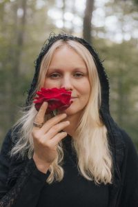 Caroline smelling a rose.